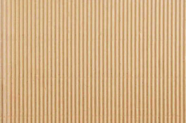 Background texture brown corrugated board fragment close-up.