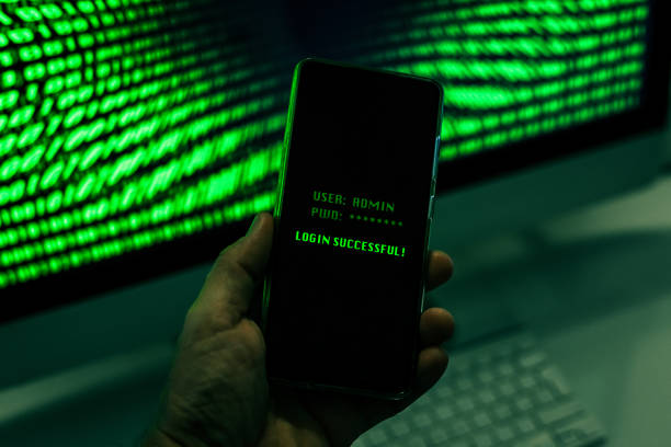istock Hand with smartphone doing successful login in a digital network. Display with green numbers in background. Hacker forced the system. Technology, communication, security, protection, intrusion concept 1347721515
