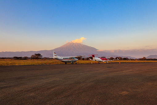 Small propeller airplanes on a background of Meru mountain in Arusha airport, Tanzania