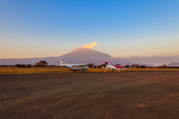 Small propeller airplanes on a background of Meru mountain in Arusha airport, Tanzania stock photo