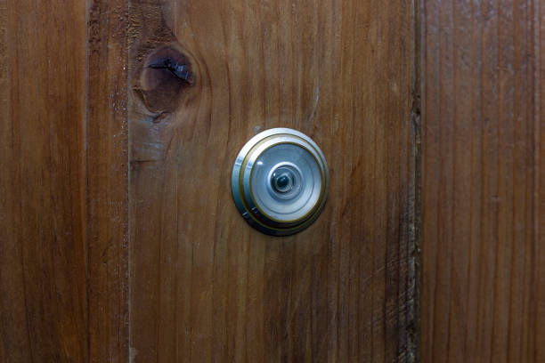 istock peephole on a wooden door, close-up 1347724498