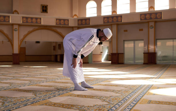 Shot of a young muslim man praying in a mosque God's pleasure is my aim salah islamic prayer photos stock pictures, royalty-free photos & images