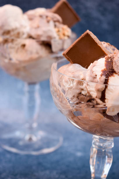 istock Ice cream with chocolate in crystal glasses 1347732346