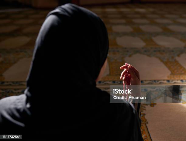 Rearview Shot Of A Muslim Woman Holding Prayer Beads In A Mosque Stock Photo - Download Image Now