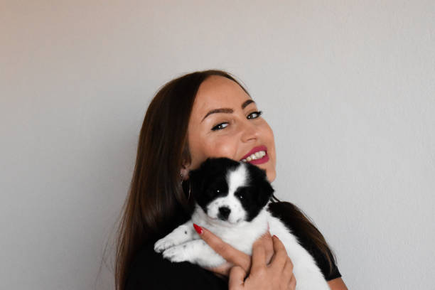 istock Woman and holding puppy 1347732585