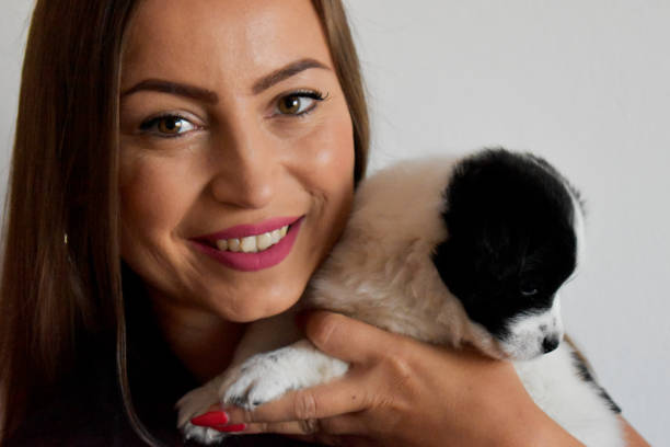 istock Woman and holding puppy 1347732640