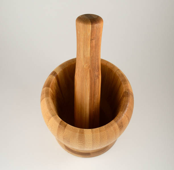 istock wooden mortar and pestle on white background 1347733824