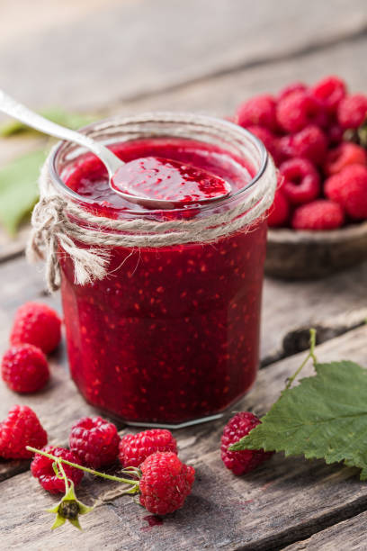 istock homemade raspberry jam on a wooden background with fresh raspberries, selective focus. 1347735334