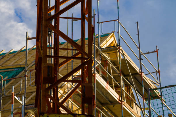 istock Scaffolding and crane around the house 1347739115