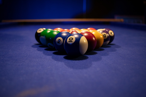 game with colorful pool balls on the blue table.