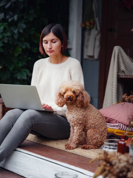 istock woman with laptop working outdoors in garden 1347741522
