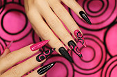 Fashionable pink and black manicure.