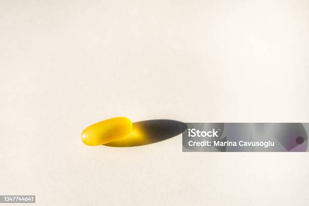 Yellow Capsules Of Nutraceuticals In Spoon Pills And Meds Stock Photo - Download Image Now