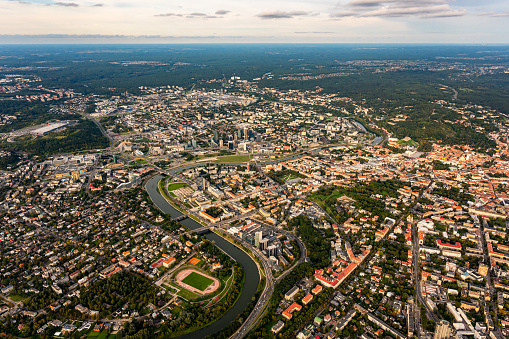 Scenic view on central part of Vilnius capital of Lithuania from hot air balloon. Neris river flowing curve through the city. Downtown district cityscape view from the sky