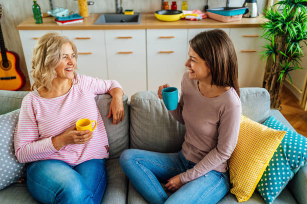 istock Mother and daughter drinking coffee at home 1347746483
