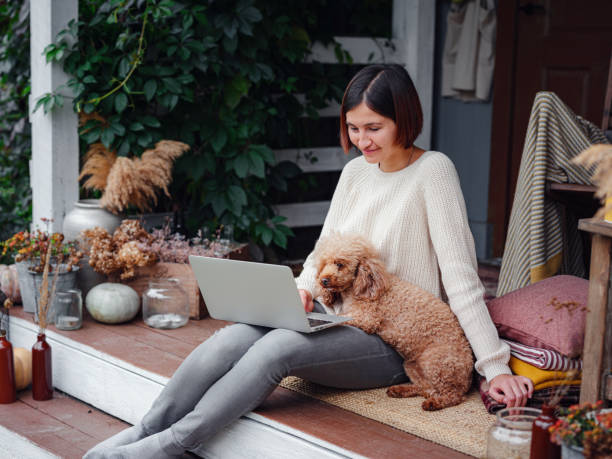 woman with laptop working outdoors in garden