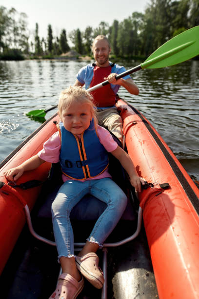 istock Resting family floats on canoe boat in river 1347747109