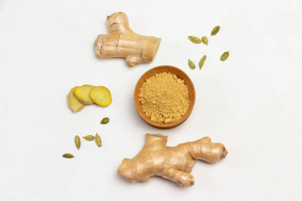 istock Dry ginger in bowl. Ginger root and cardamom seeds. 1347748015