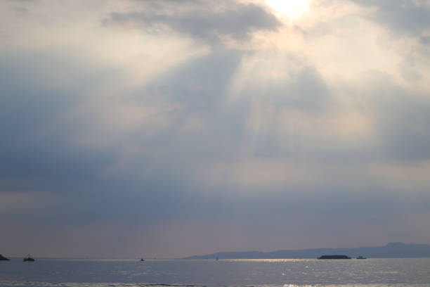 istock Seascape view with horizon over the water on a cloudy day with sun rays through a dramatic grey sky at Batu Bintang Beach Pelabuhanratu, Sukabumi, Indonesia. 1347754113