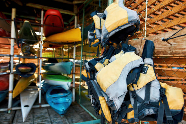 istock Life vests on hangers and kayaks in storage 1347759490