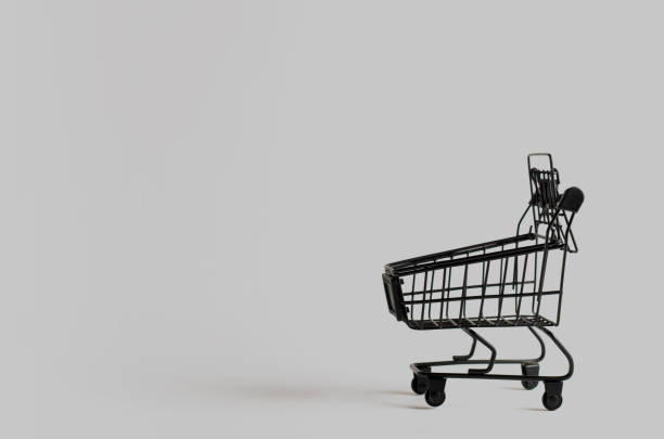 istock Black toy shopping cart on gray background with copy space. 1347759716
