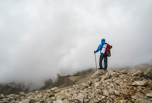 Mountaineer hiking on the edge of a rocky mountain path near  Mount Tahtali, Antalya, Turkey