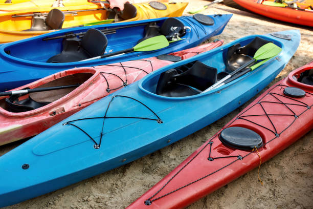 istock Collection of kayaks with paddles on coast 1347761314