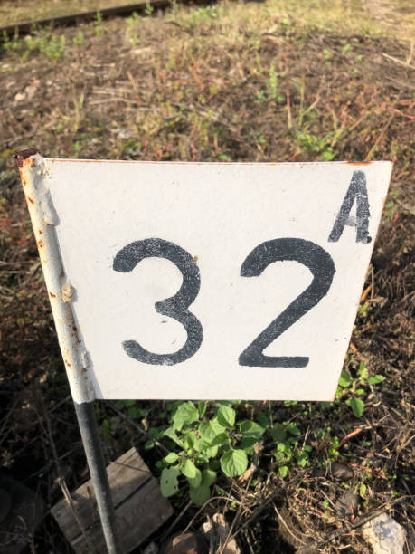 istock black number 32 on a white metal plate 1347761326