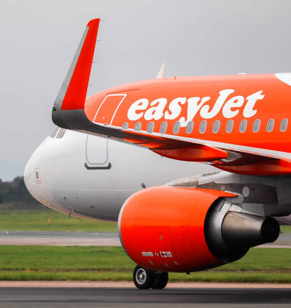 Manchester, United Kingdom - 17 October, 2021: EasyJet Airbus A320 (G-EZOP) taxiing to Terminal 1 after landing at Manchester Airport.