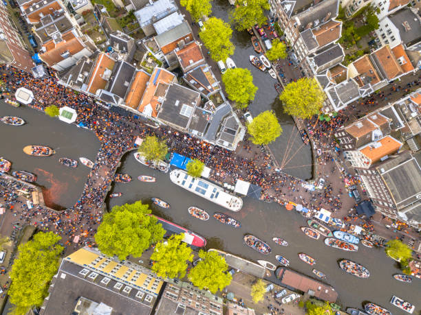 Boat parade Kings day Canal boat parade on Koningsdag Kings day festivities in Amsterdam. Birthday of the king. Seen from helicopter. jordaan amsterdam stock pictures, royalty-free photos & images