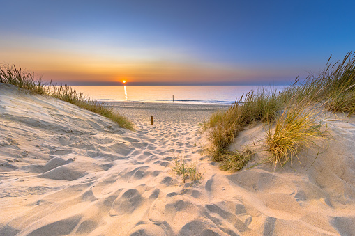 Inviting Sunset View over ocean from dune over North Sea and Canal in Ouddorp, Zeeland Province, the Netherlands. Outdoor scene of coast in nature of Europe.