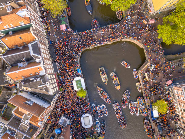 Boat parade Kings day Canal boat parade on Koningsdag Kings day festivities in Amsterdam. Birthday of the king. Seen from helicopter. jordaan amsterdam stock pictures, royalty-free photos & images