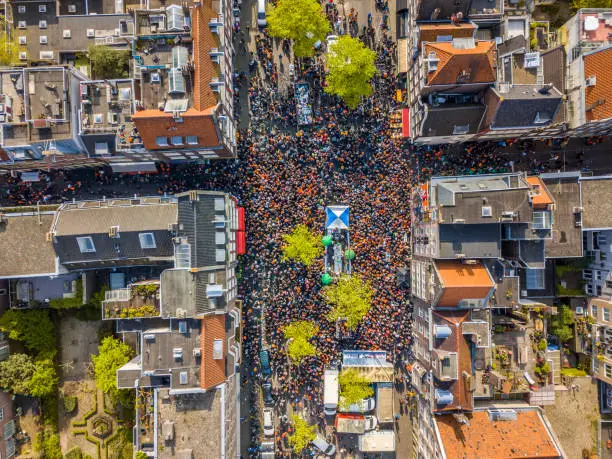 Aerial view of Huge crowd in Westerstraat on Koningsdag Kings day festivities in Amsterdam. Birthday of the king. Seen from helicopter.