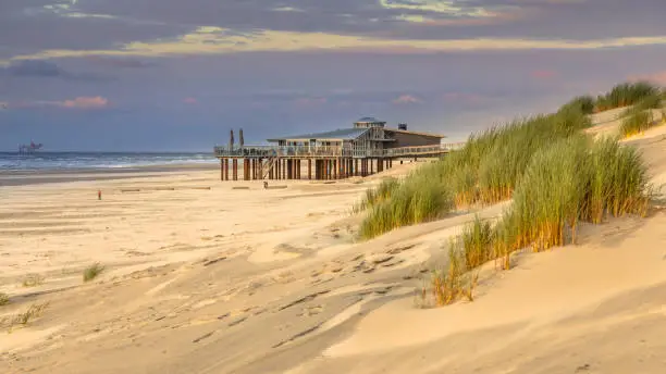 View from dune top over sunset in North Sea from the island of Ameland, Friesland, Netherlands