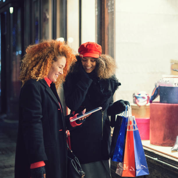 young beautiful women shopping together for the christmas - ipad shopping gift retail imagens e fotografias de stock
