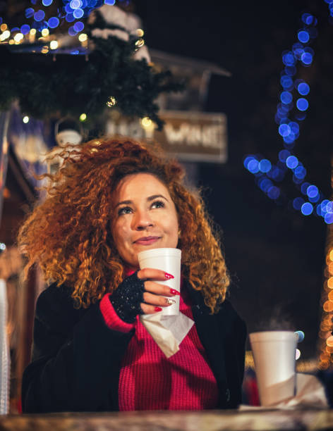 young beautiful woman drinking hot drinks and having fun at christmas market - ipad shopping gift retail imagens e fotografias de stock