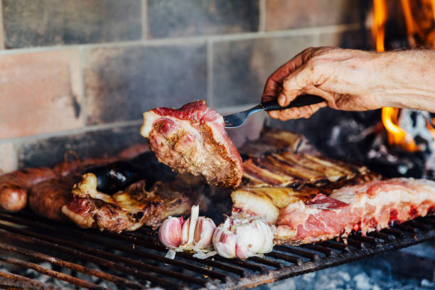 istock Argentinian meat roasting on the grill. Man making a traditional barbecue called Asado in Argentina. 1347782959