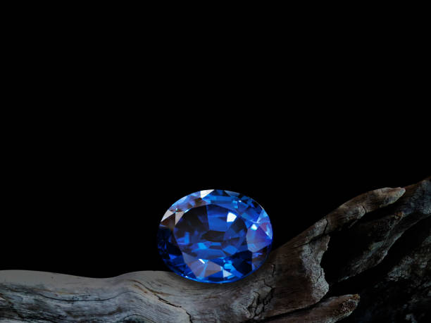 istock blue sapphire on old wooden with black background 1347784640