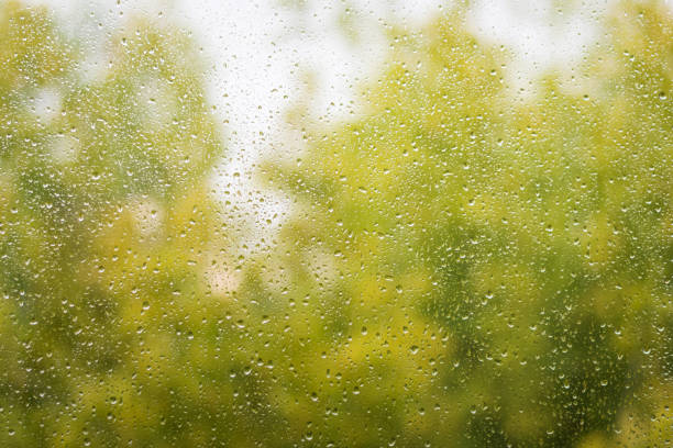 Autumn glass window with raindrops