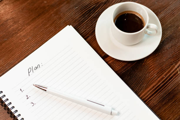 Blank notebook for writing and coffee cup