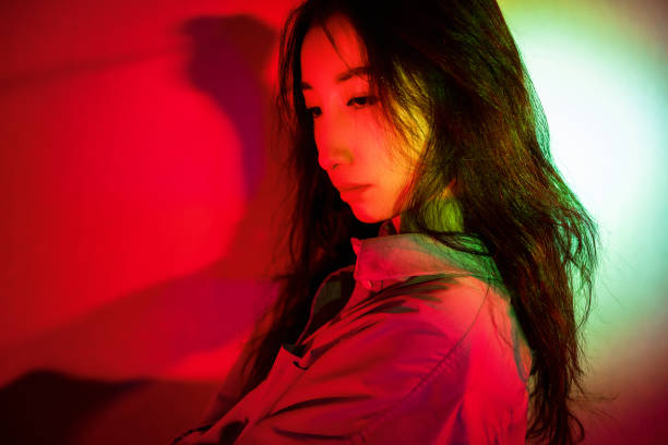 istock Beautiful woman with red light 1347791142
