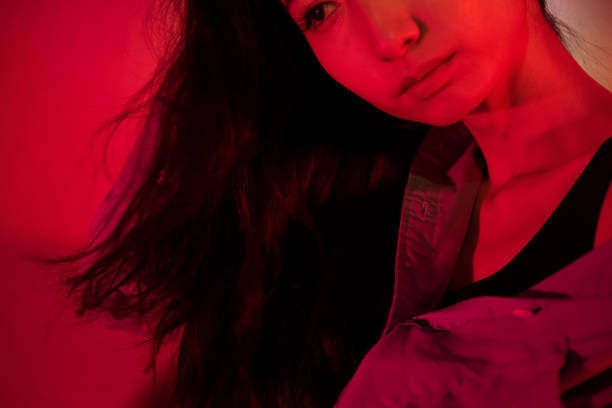 istock Beautiful woman with red light 1347791717