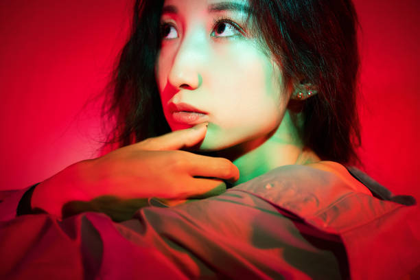istock Beautiful woman with red light 1347791733