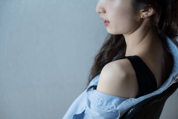 istock The bare-shouldered girl sat on a black chair 1347793460