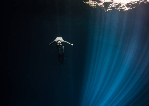 istock Freediver swimming in the surface of a Cenote 1347796479