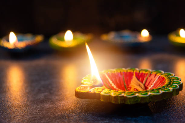 istock clay lit light a fire already on Diya or oil lamp 1347798243
