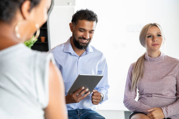 istock Diverse group of adults in support group 1347798391