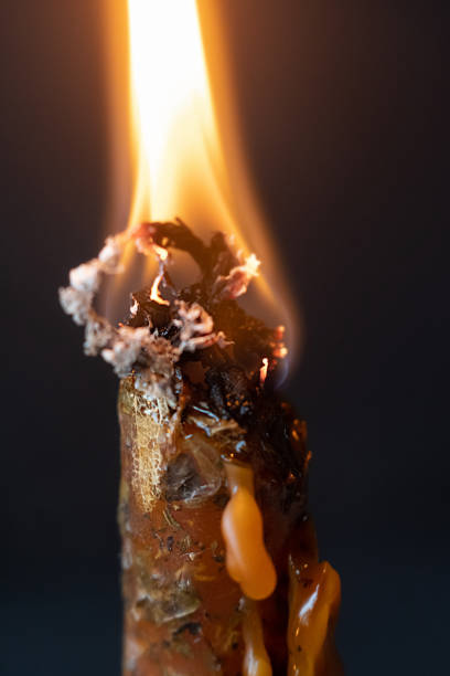 istock wax of burning orange wax candle melts. selective focus 1347801980