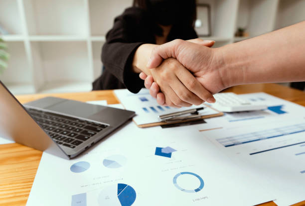 business partnership handshake concept.Photo of two businessmen handshaking process. Successful deal after great meeting. business partnership handshake concept. Photo of two businessmen handshaking process. Successful deal after great meeting. contracting stock pictures, royalty-free photos & images