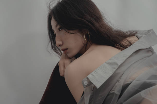 istock Stylish woman with bare back wearing silver earrings 1347806374